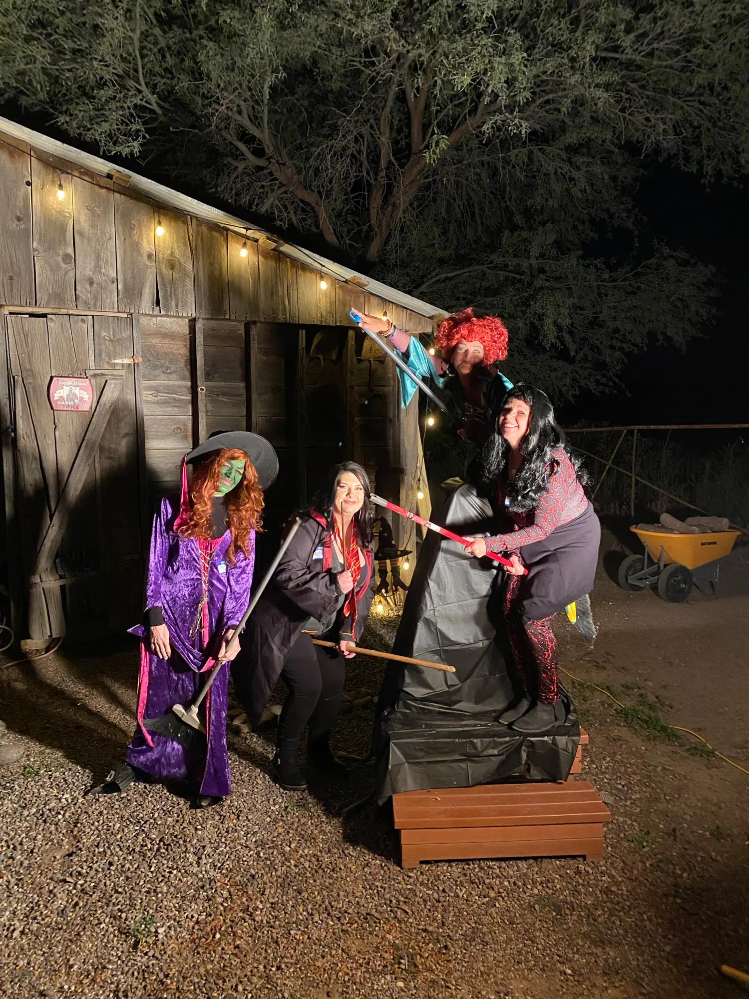 A costumed group photographed at the barn at night